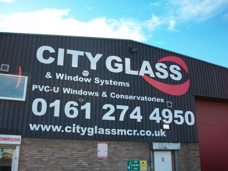 City Glass flat cut letters mounted to cladding